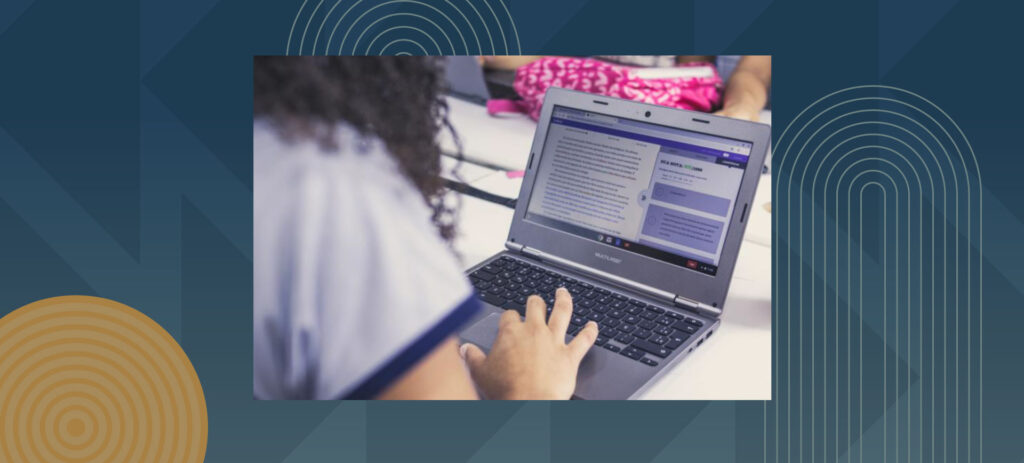 Person typing on laptop computer showing purple interface with hands positioned on keyboard