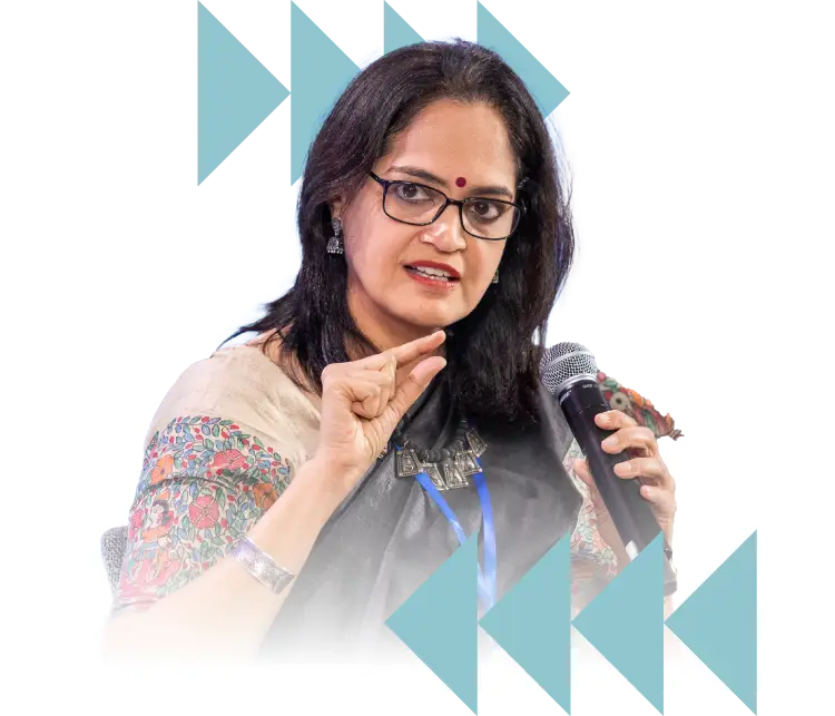 Woman speaking into a microphone during a public discussion or presentation – Co-Impact website