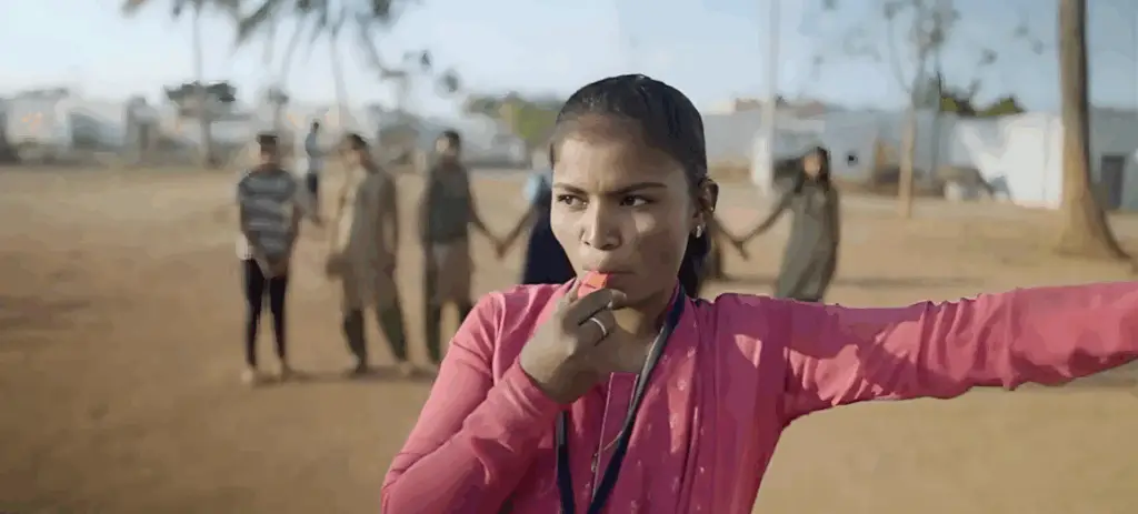 Young woman leading an outdoor group activity | Co-Impact website